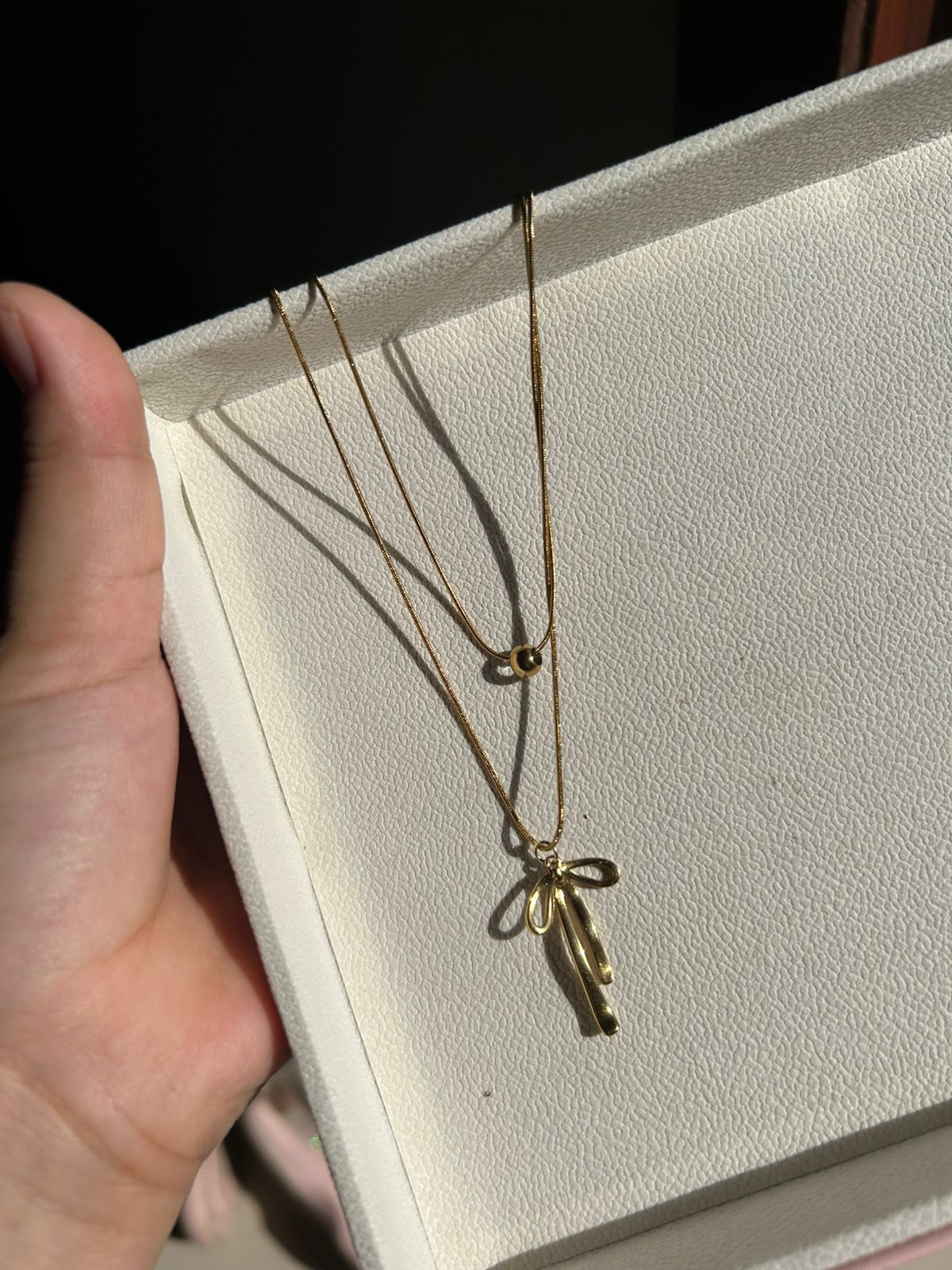 Double chain bow pendant